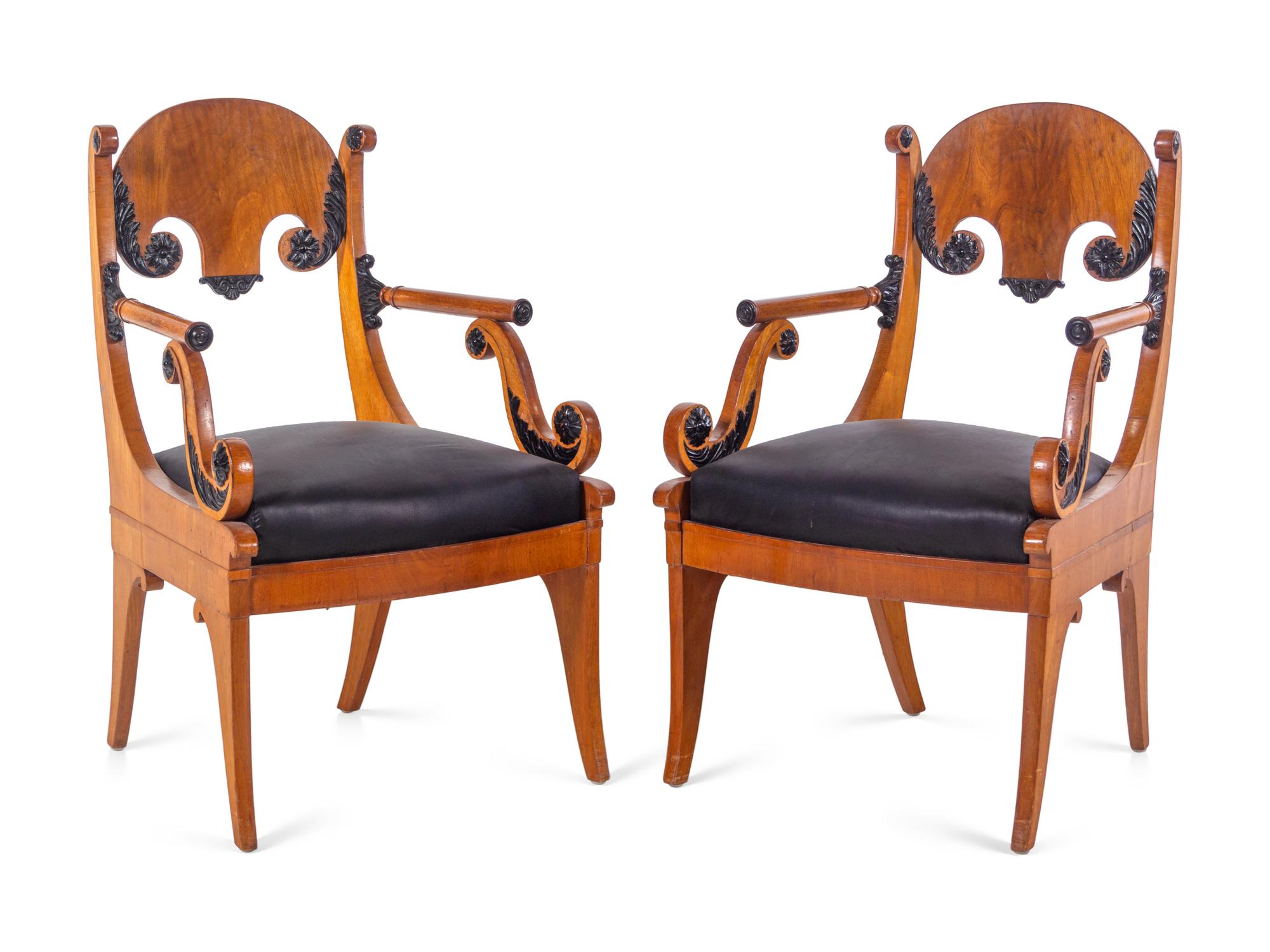 A Pair of Biedermeier Parcel Ebonized Armchairs