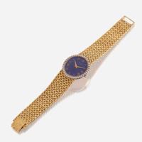 An eighteen karat gold, lapis lazuli, and diamond bracelet wristwatch, Piaget