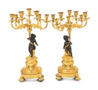 A Pair of French Gilt and Patinated Bronze Figural Seven-Light Candelabra