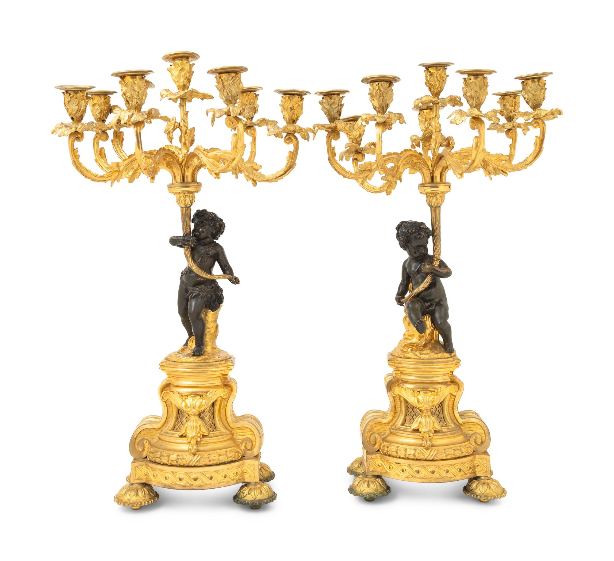 A Pair of French Gilt and Patinated Bronze Figural Seven-Light Candelabra