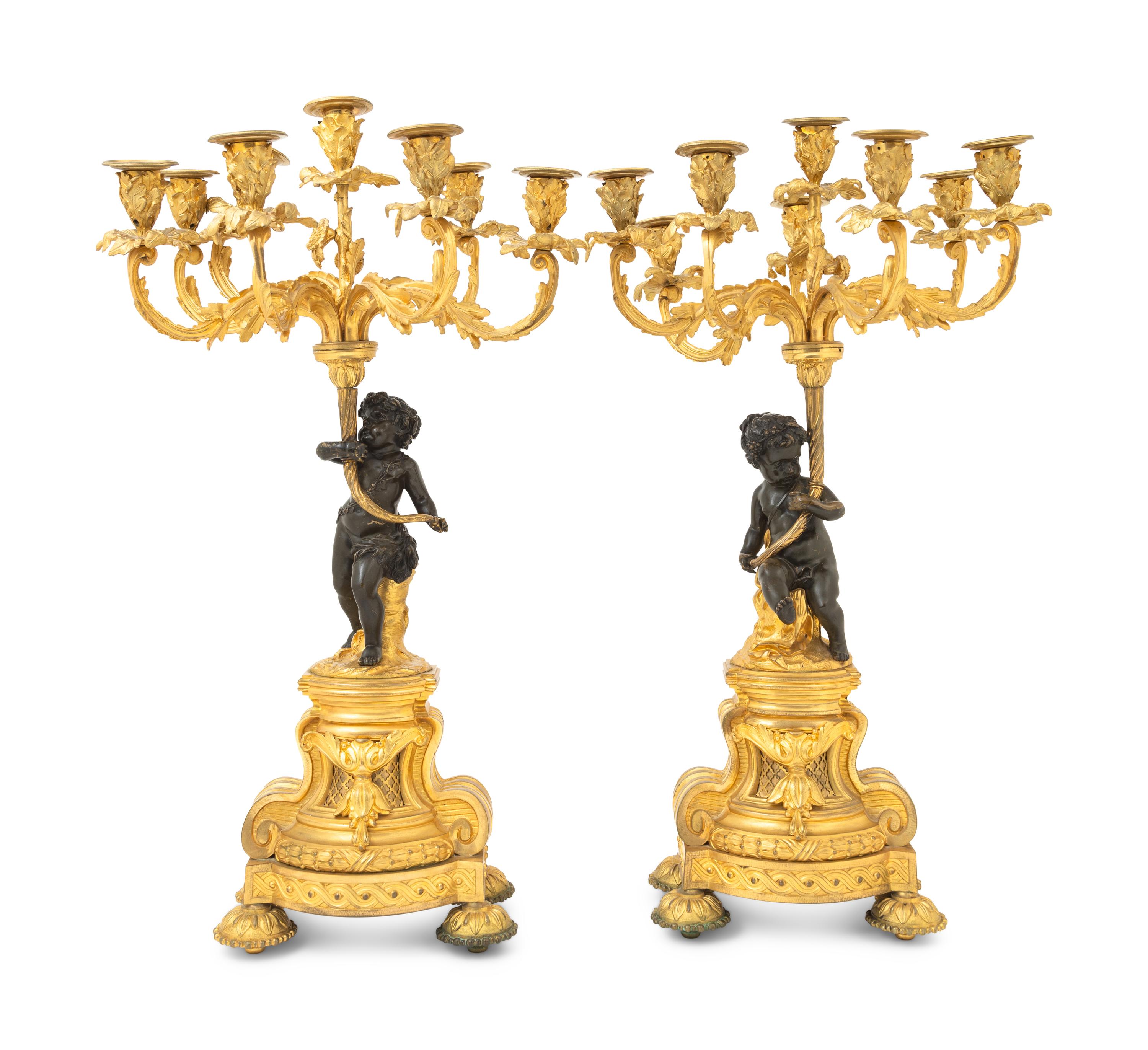 A Pair of French Gilt and Patinated Bronze Figural Seven-Light Candelabra