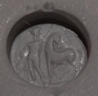A Roman Carnelian Ring Stone with a Standing Man and Horse, Possibly Castor or Pollux — Set in a gold pendant