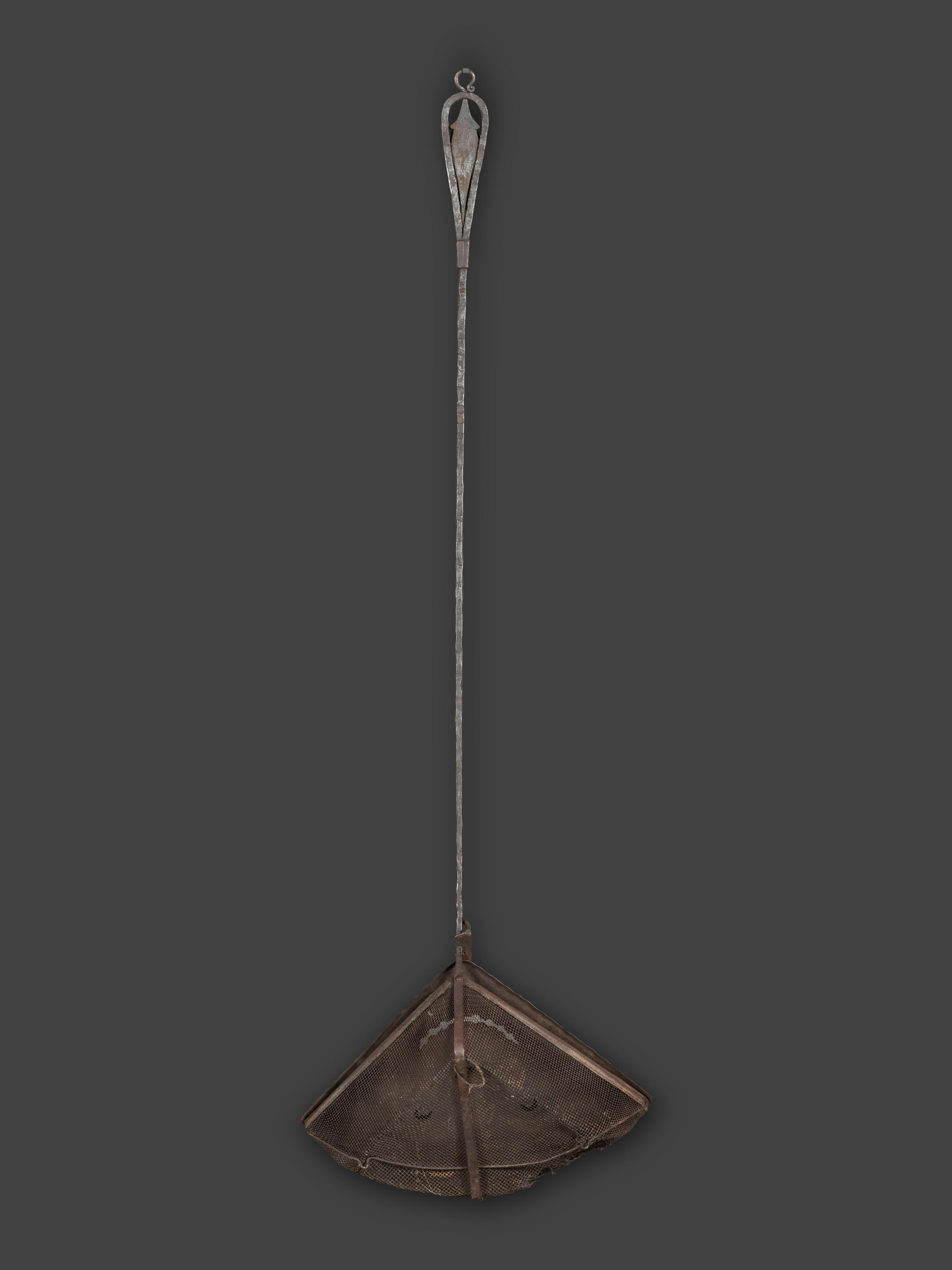 A Forged and Hammered Iron Figural Chestnut Roaster