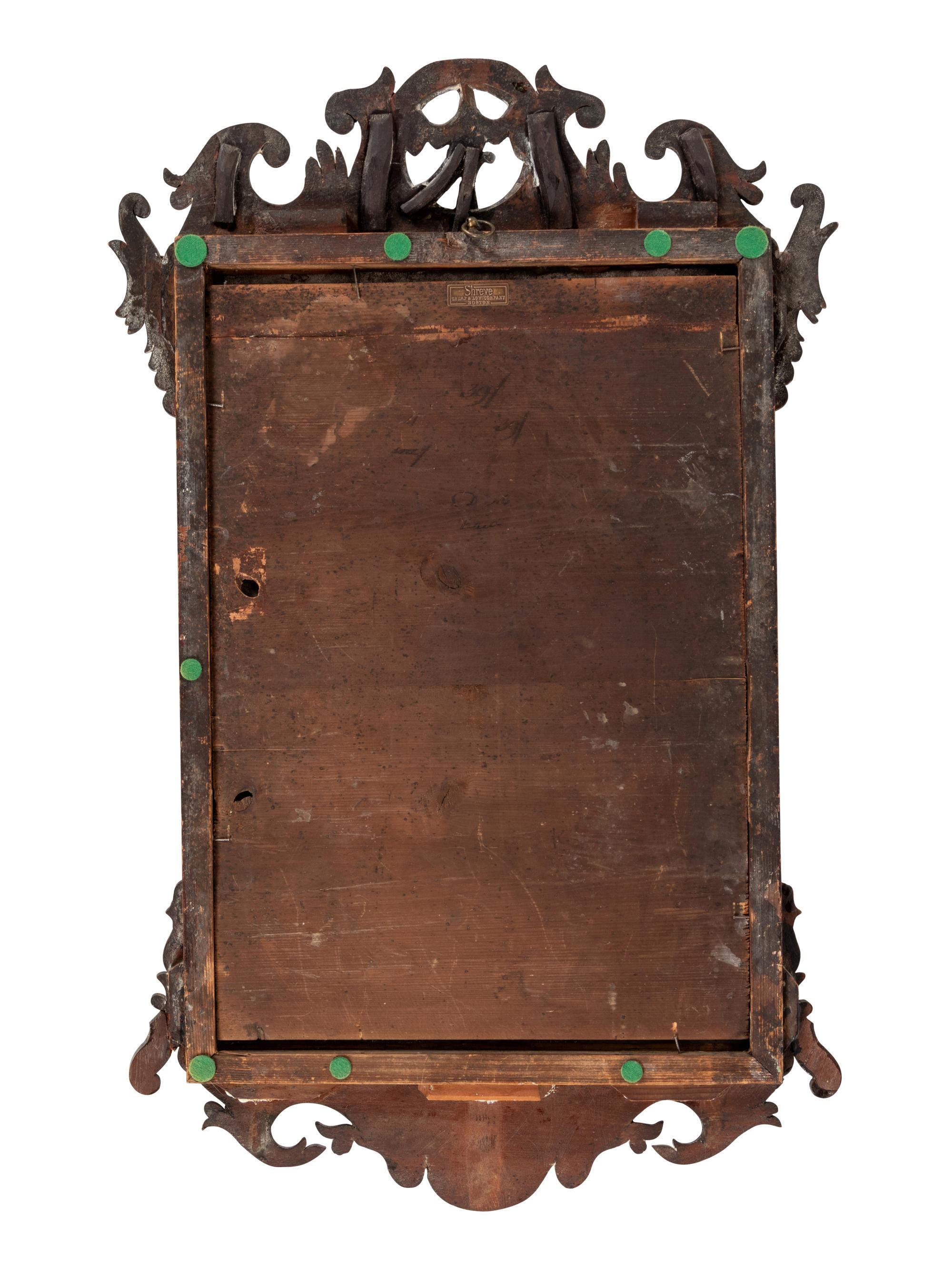 A Chippendale Parcel Gilt and Carved Mahogany Looking Glass