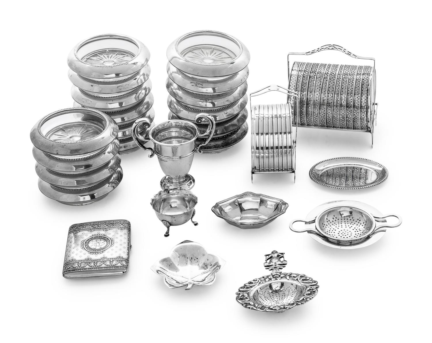 comprising: 8 small plates 4 footed salts 5 nut dishes 8 silver and glass coasters 12 silver and glass coasters 2 tea strainer 1 cigarette case 1 card case 1 leaf dish 1 cigarette holder 16 silver and glass coasters 59 items total.