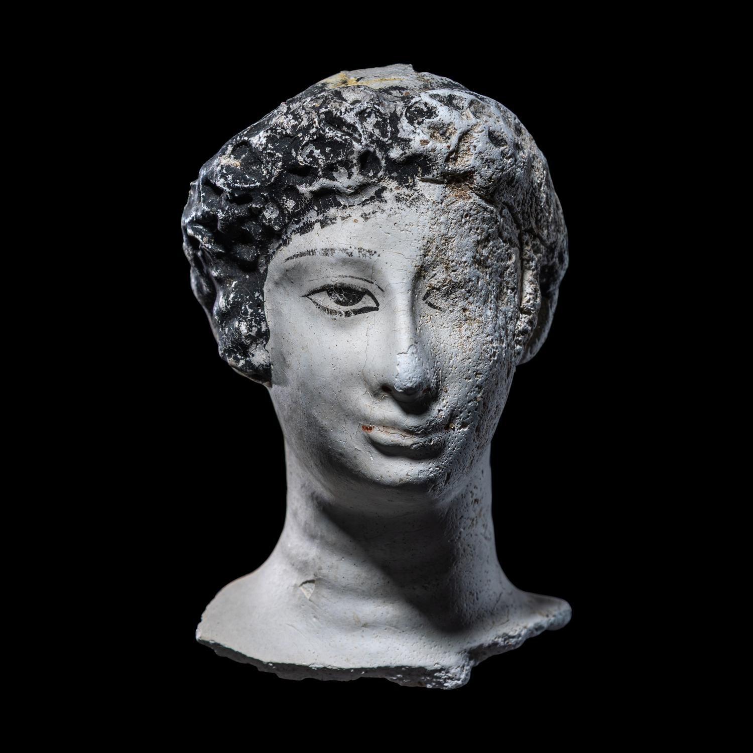 An Egyptian Painted Stucco Mummy Mask