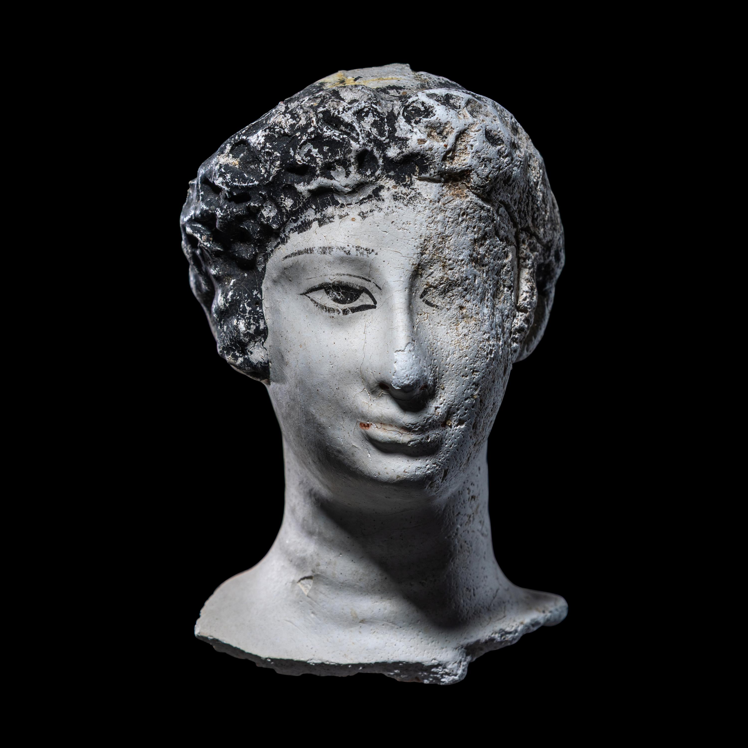 An Egyptian Painted Stucco Mummy Mask