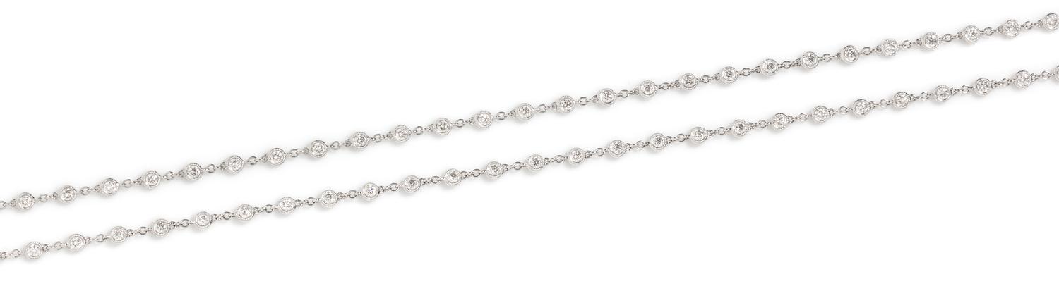 An 18 Karat White Gold and Diamond Station Necklace, 13.70 dwts.