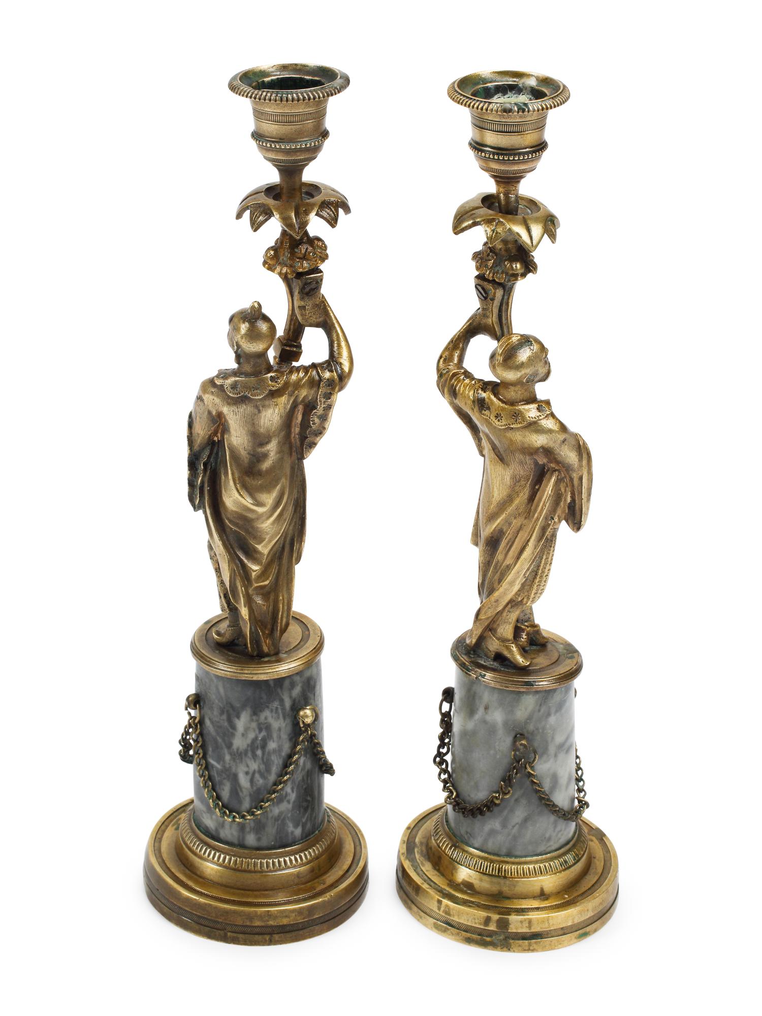 A Pair of French Bronze Figural Candlesticks on Marble Bases