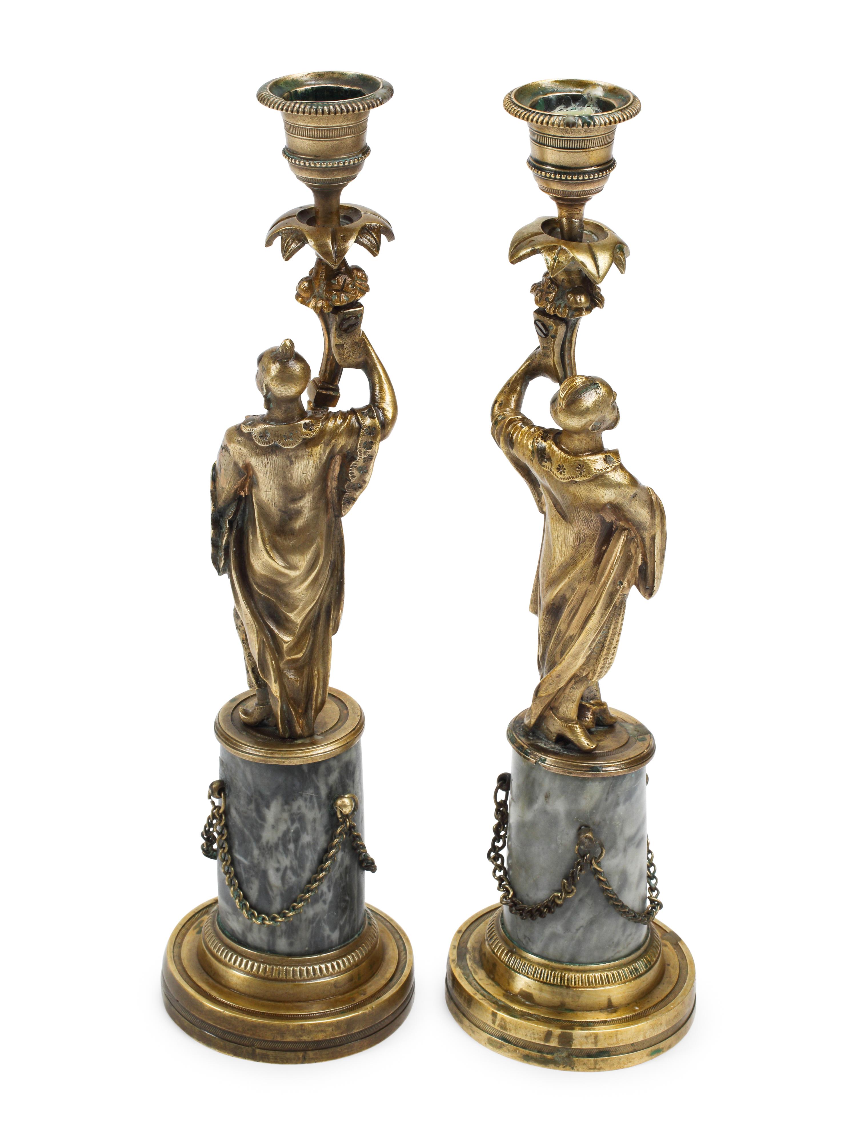 A Pair of French Bronze Figural Candlesticks on Marble Bases
