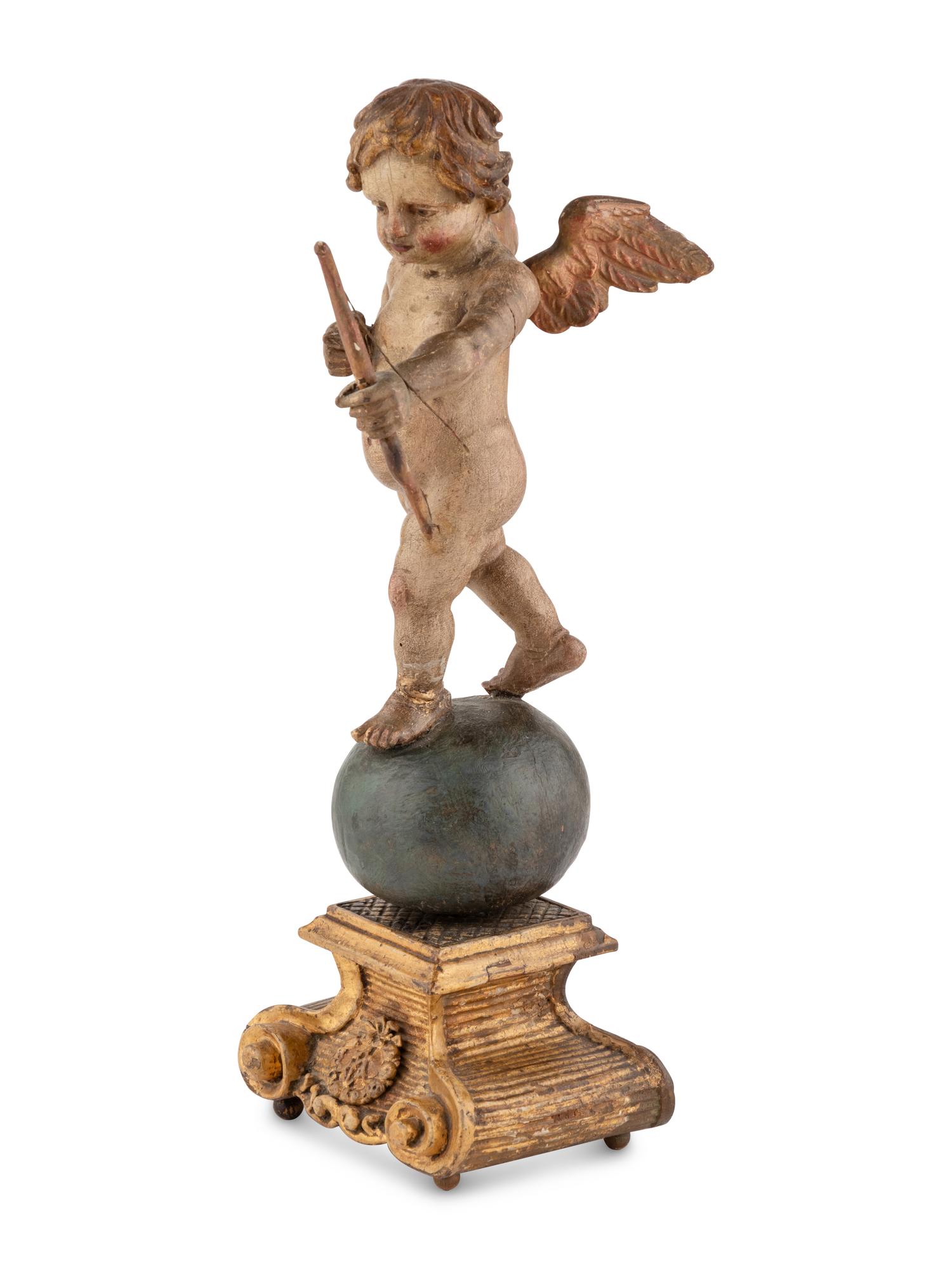 A Continental Painted and Parcel Gilt Cherub Ornament