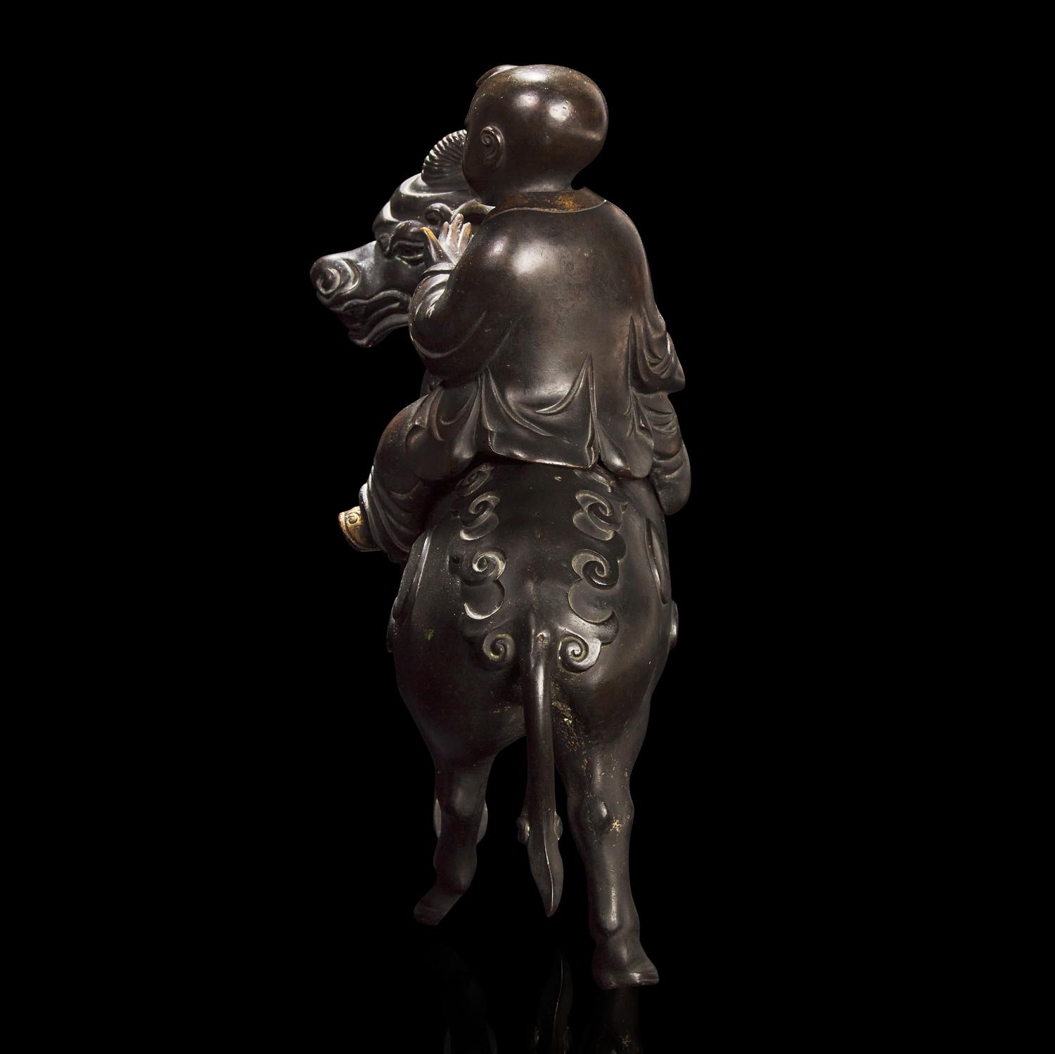 A Chinese Patinated and Parcel-gilt Bronze 'Qilin and Boy' Censer, 17th/18th Century 清早期 銅局部鎏金麒麟童子香薰