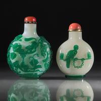 Two Chinese Green-Overlaid Glass Snuff Bottles, Qing Dynasty, 18th and 19th Centuries — 清中期 涅白地套綠料及雪霏地套綠料鼻煙壺兩支