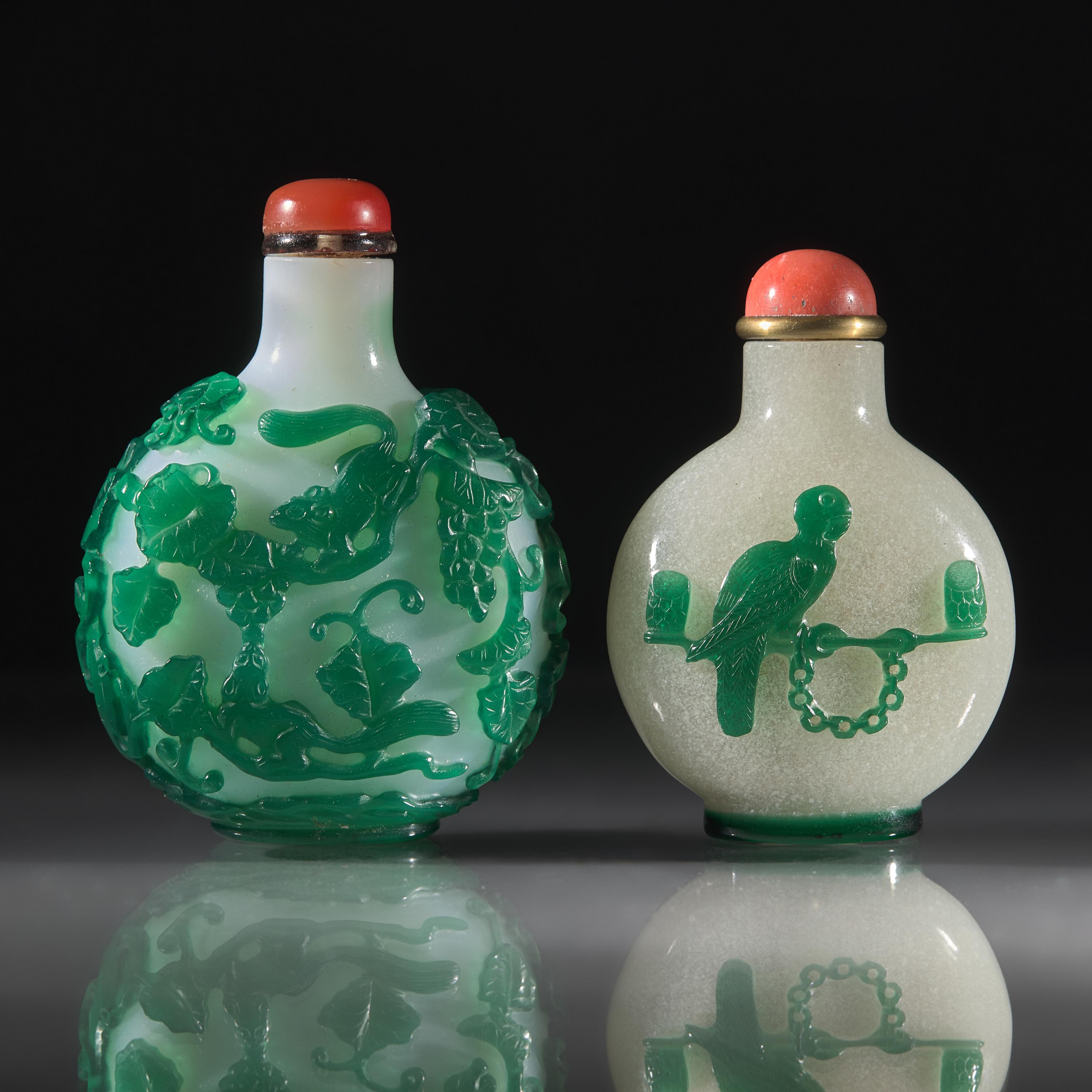 Two Chinese Green-Overlaid Glass Snuff Bottles, Qing Dynasty, 18th and 19th Centuries — 清中期 涅白地套綠料及雪霏地套綠料鼻煙壺兩支