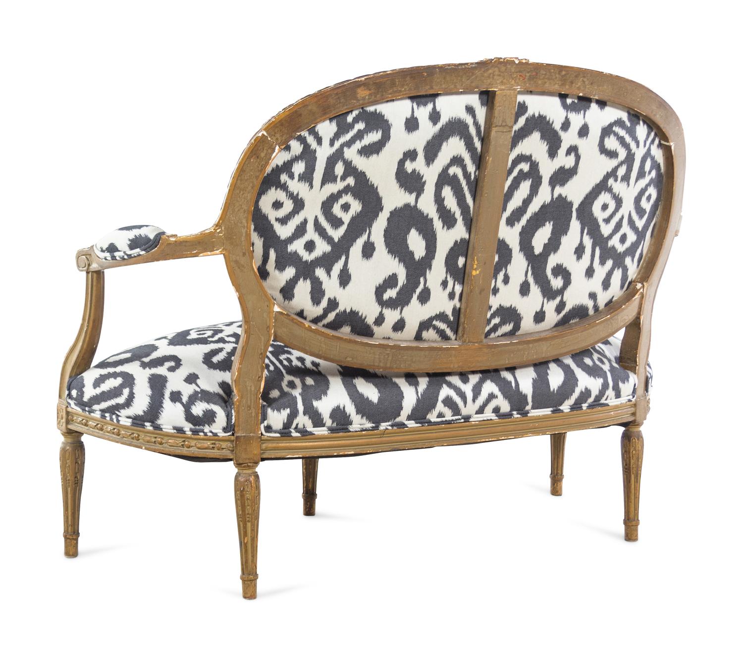 A Louis XVI Style Brunschwig & Fils Upholstered Giltwood Oval Back Settee