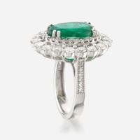 An emerald, diamond, and white gold ring