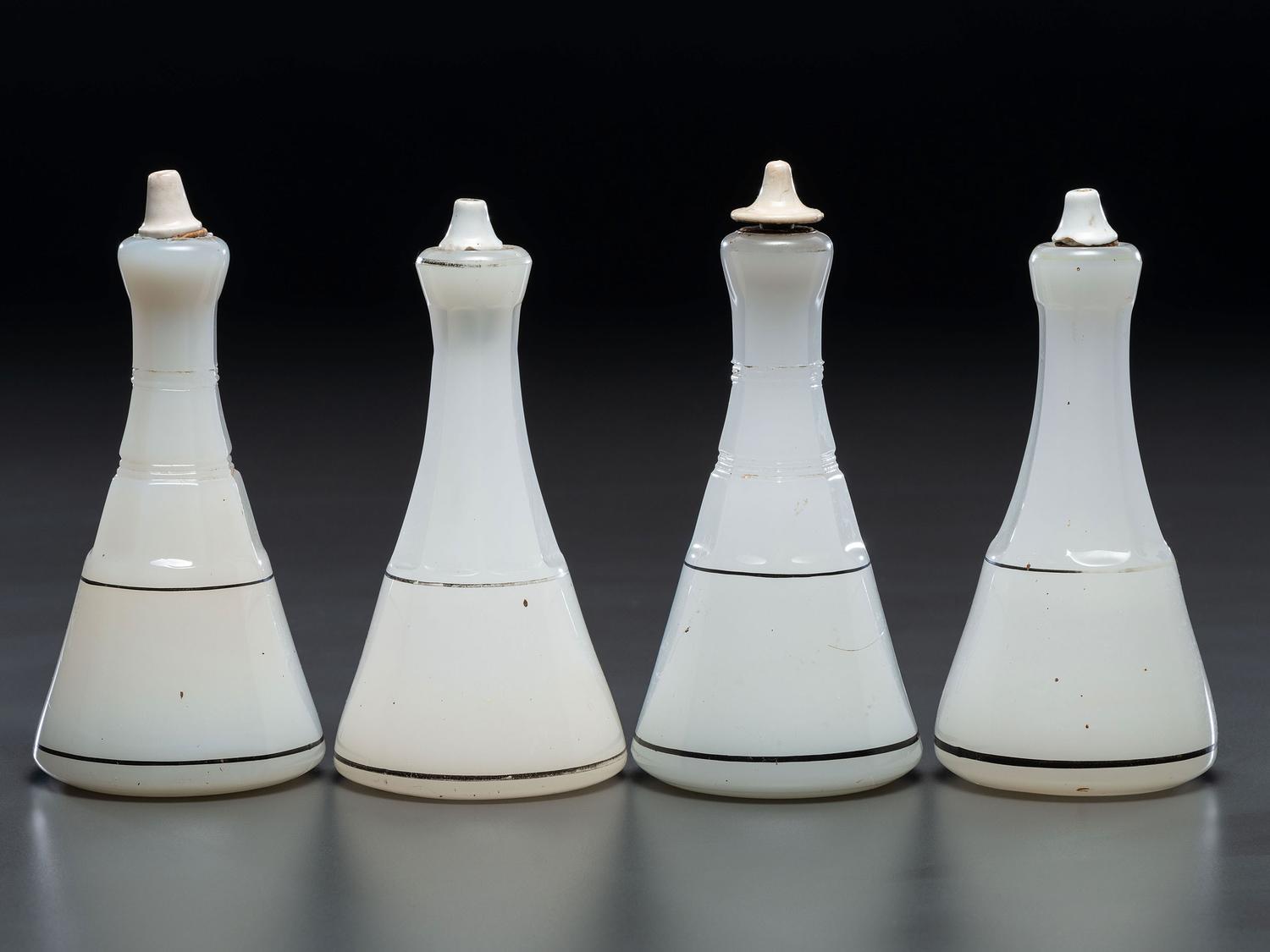 Four Milk Glass Barber Bottles with Ceramic Stoppers