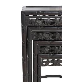 A Set of Four Chinese Ebonized Carved Teak Nesting Tables