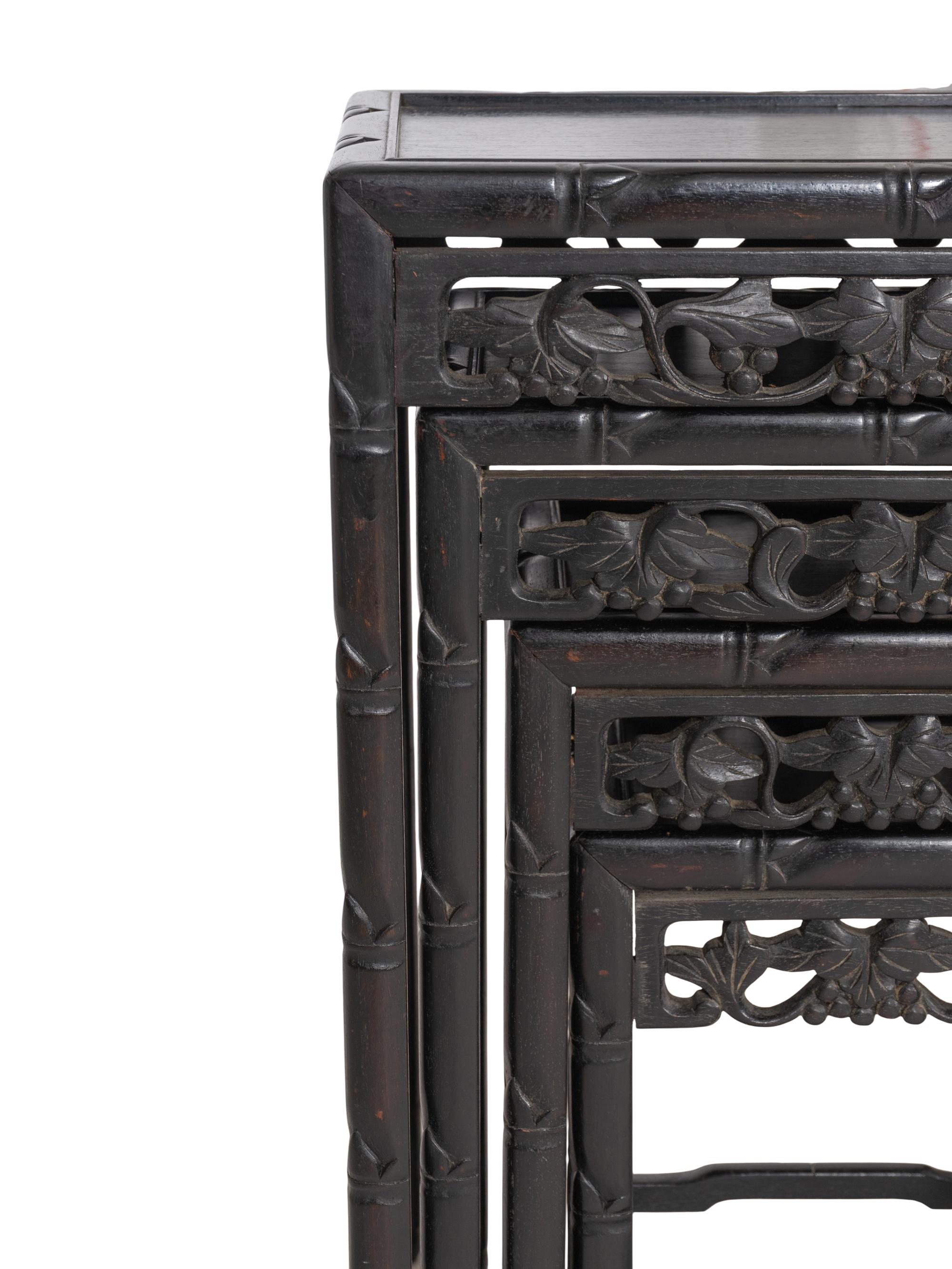 A Set of Four Chinese Ebonized Carved Teak Nesting Tables