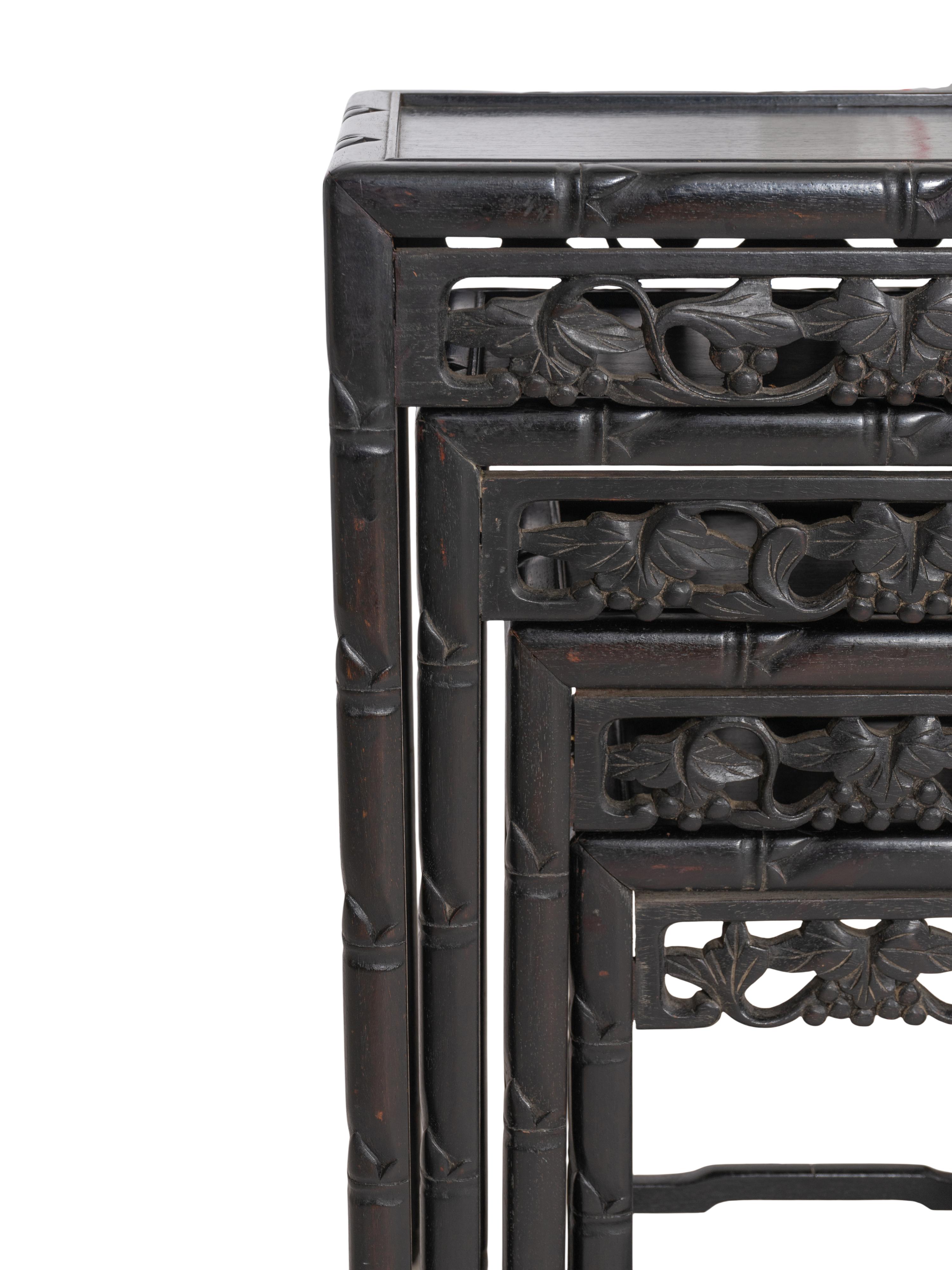 A Set of Four Chinese Ebonized Carved Teak Nesting Tables