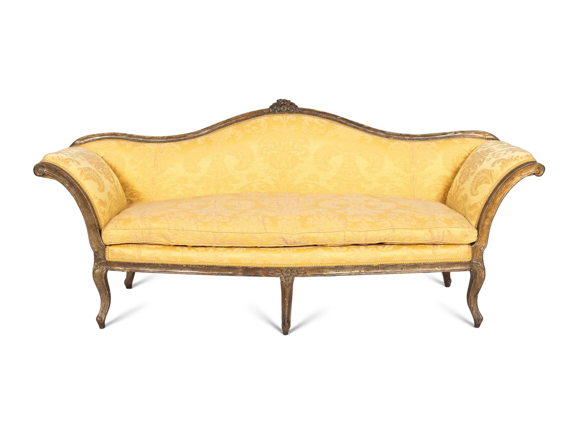 An Italian Rococo Silvered and Gilt Walnut Sofa