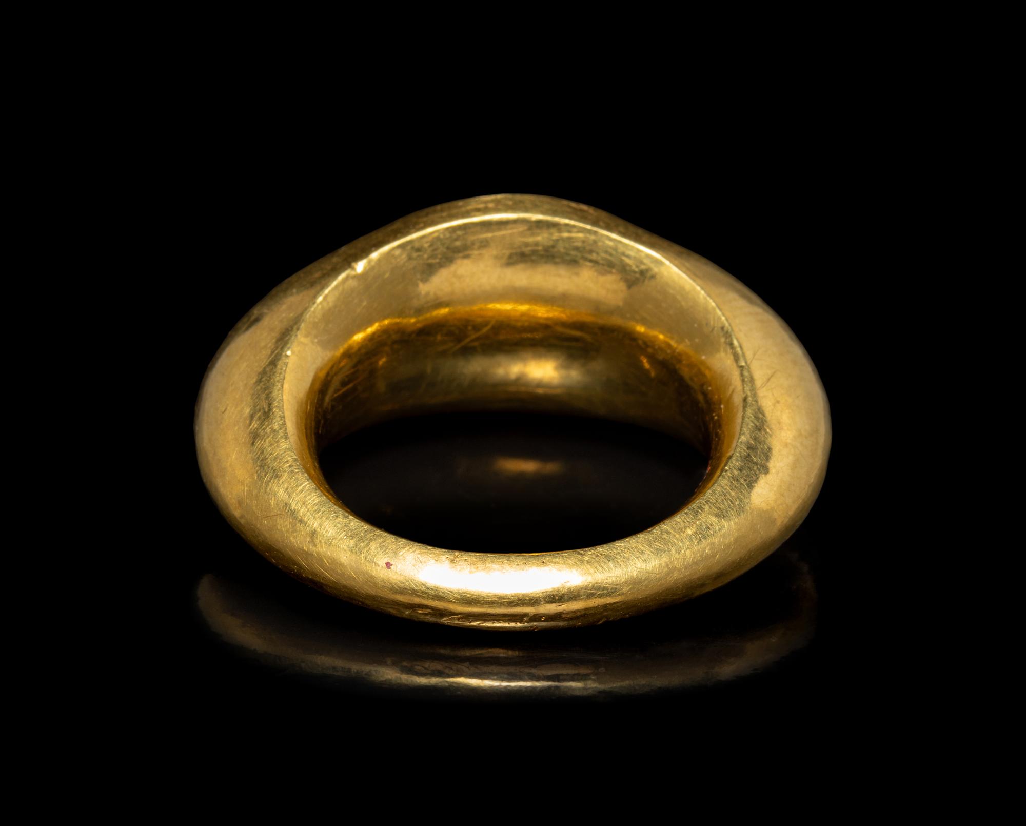 A Roman Gold and Garnet Finger Ring with the God Eros