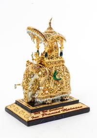 An Indian Gilt Decorated Composite Model of an Elephant Height overall 8 inches.