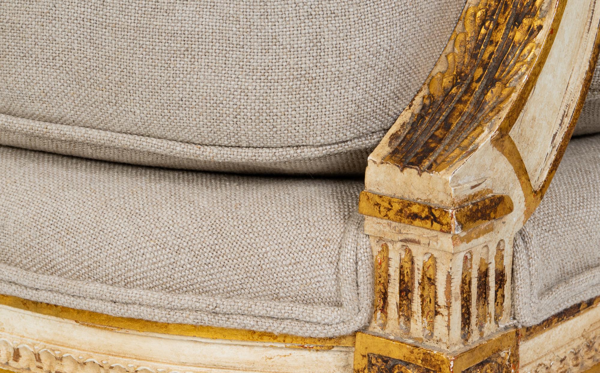 A Pair of Louis XVI Style Painted and Parcel Gilt Fauteuils — EARLY 20TH CENTURY