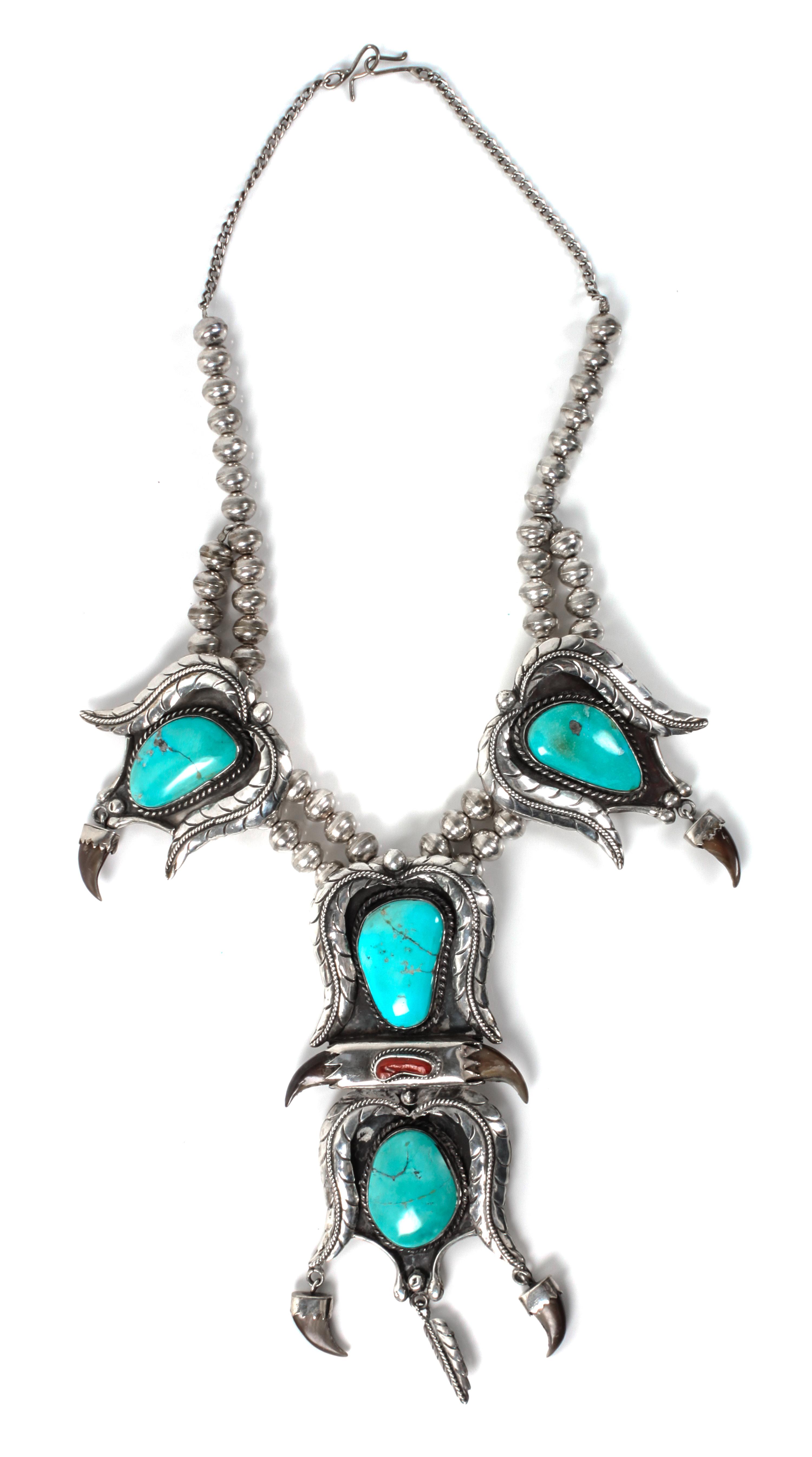 A Large Silver, Turquoise and Coral Pendant Necklace Length 20 inches; height of pendant 6 x width 2 3/4 inches.