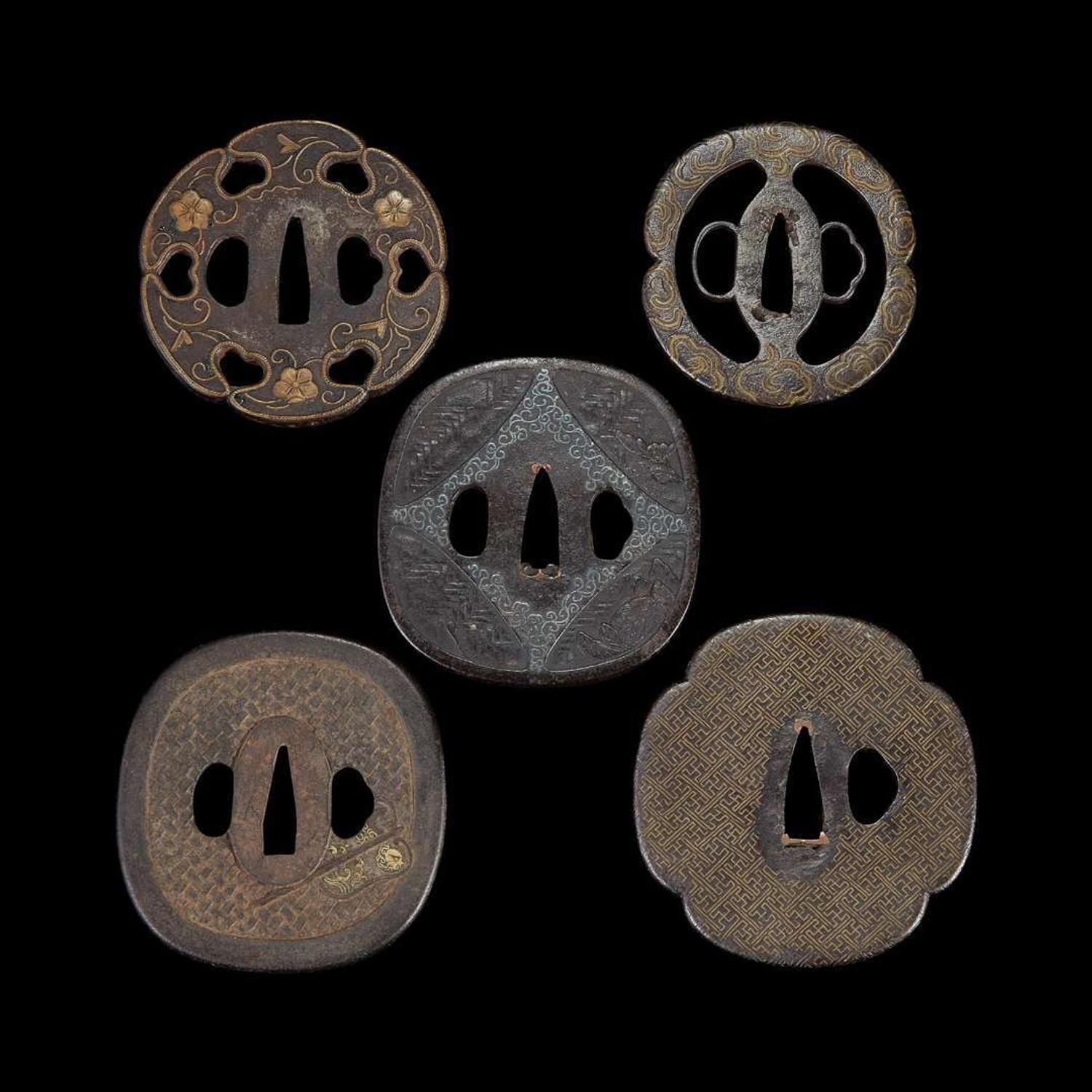 Group of ten Japanese inlaid iron tsuba Edo period or earlier
