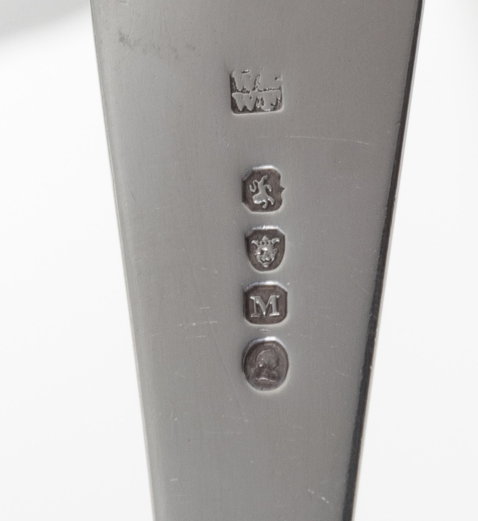A George III Silver Fish Server, William Ely & William Fearn, London, 1807, the handle with an engraved crest of an arm embowed clutchi