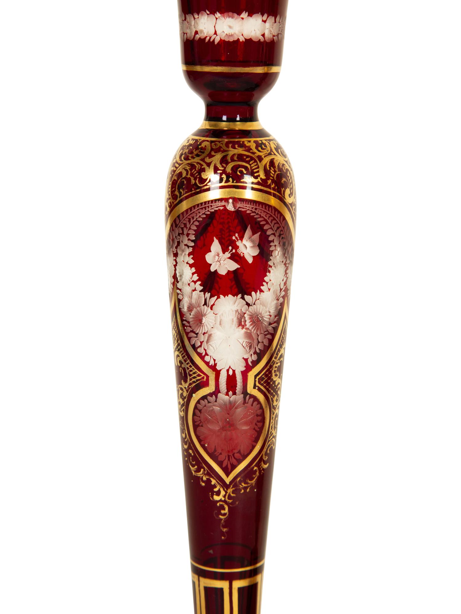 A Set of Four Bohemian Ruby Cut-to-Clear Glass Candlesticks with Gilt Decoration. — 19th Century
