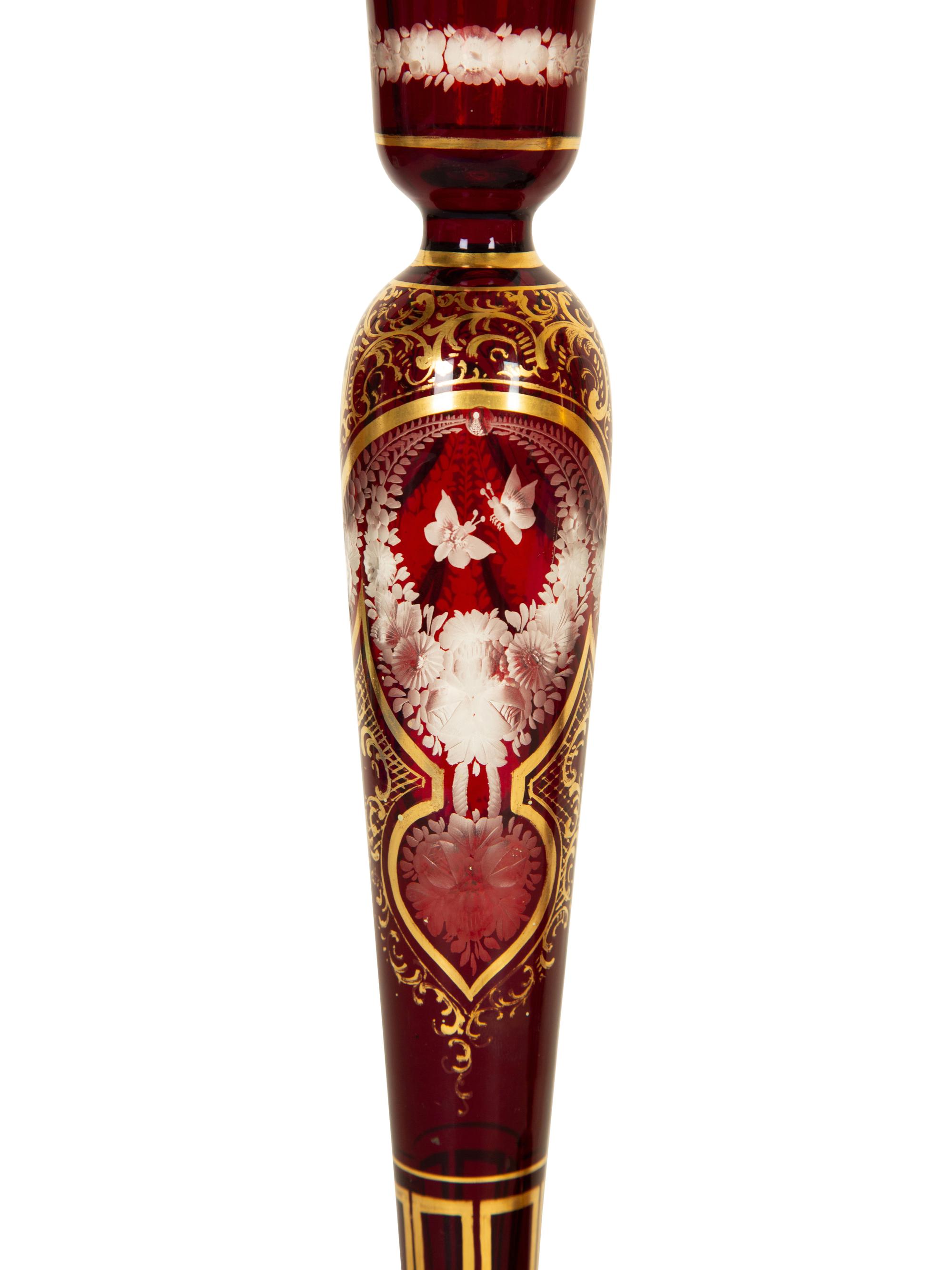 A Set of Four Bohemian Ruby Cut-to-Clear Glass Candlesticks with Gilt Decoration. — 19th Century