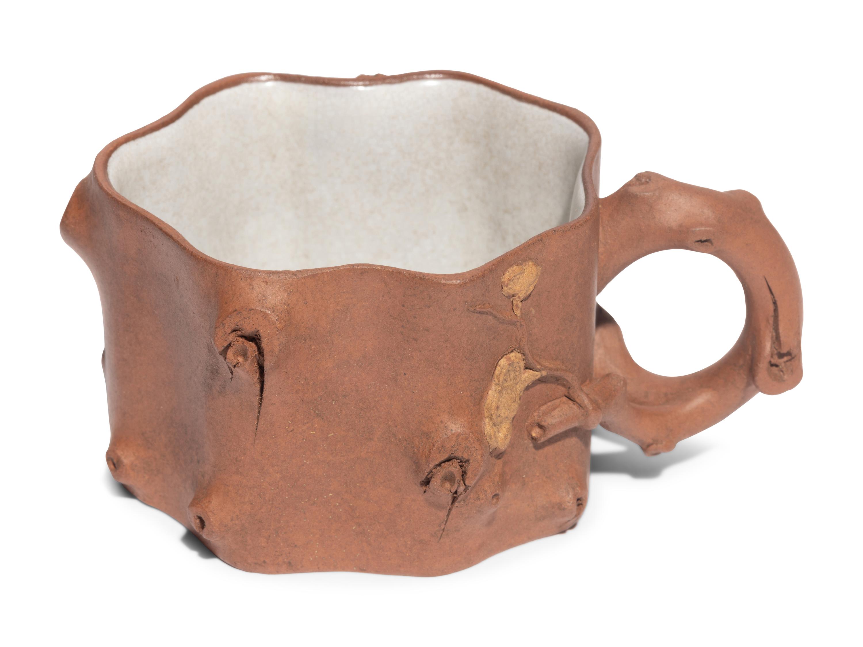 A Chinese Yixing Zisha Pottery Teapot and Four Teacups
