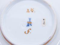 Three Meissen Painted and Parcel Gilt Porcelain Cup and Saucer Sets, a Covered Cup and Two Spoons