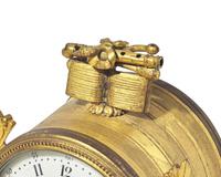 A Louis XVI Style Gilt and Patinated Bronze Mounted White Marble Three-Piece Clock Garniture
