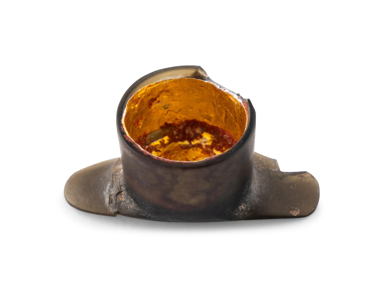 An Aztec Gold-Gilt Obsidian Labret