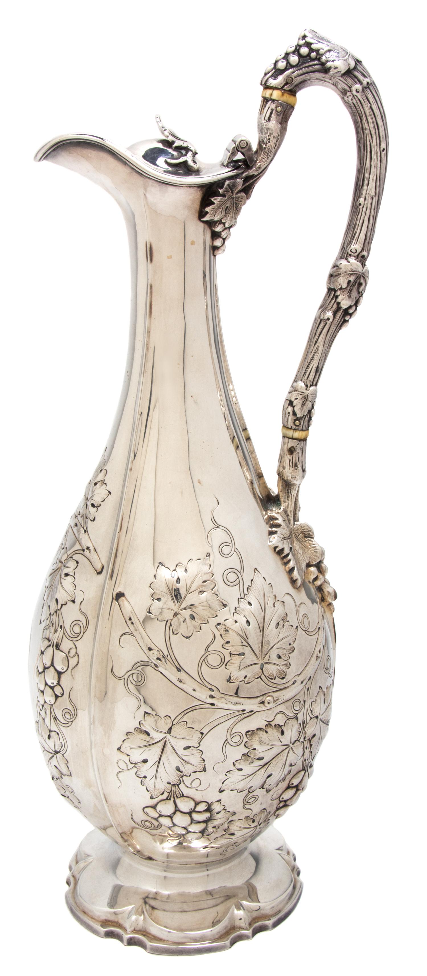 A Victorian Silver Wine Ewer, Henry Wilkinson & Co., Sheffield, 1865, having a foliate scroll handle surmounting a foliate decorated bo