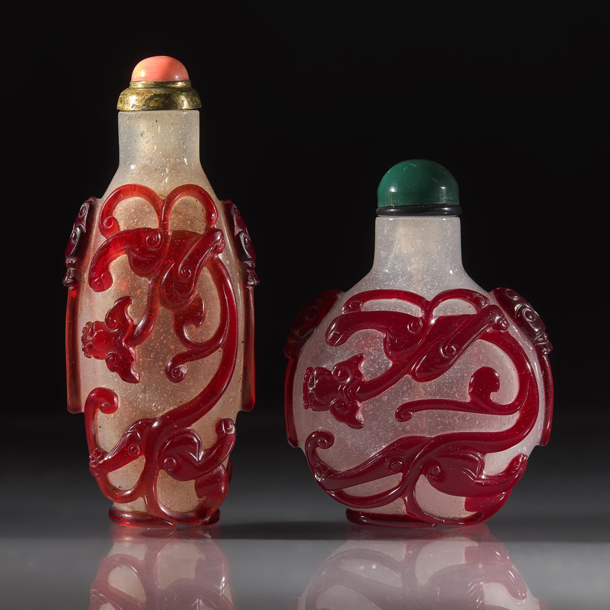 Two Chinese Carved Ruby Overlay Glass Snuff Bottles, Qing Dynasty, 18th/19th Century — 清中晚期 雪霏地套寶石紅料螭龍紋鼻煙壺兩支