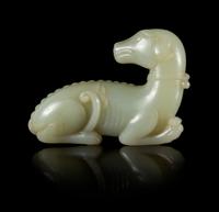 A Carved Celadon Jade Figure of a Recumbent Dog Length 3 1/2 inches.