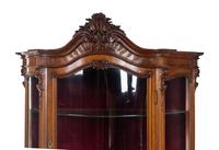 A Rococo Revival Carved Walnut Corner Vitrine Cabinet