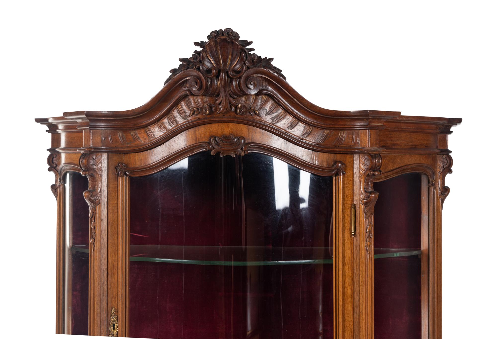 A Rococo Revival Carved Walnut Corner Vitrine Cabinet
