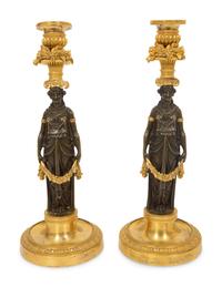 A Pair of French Gilt and Patinated Bronze Figural Candlesticks