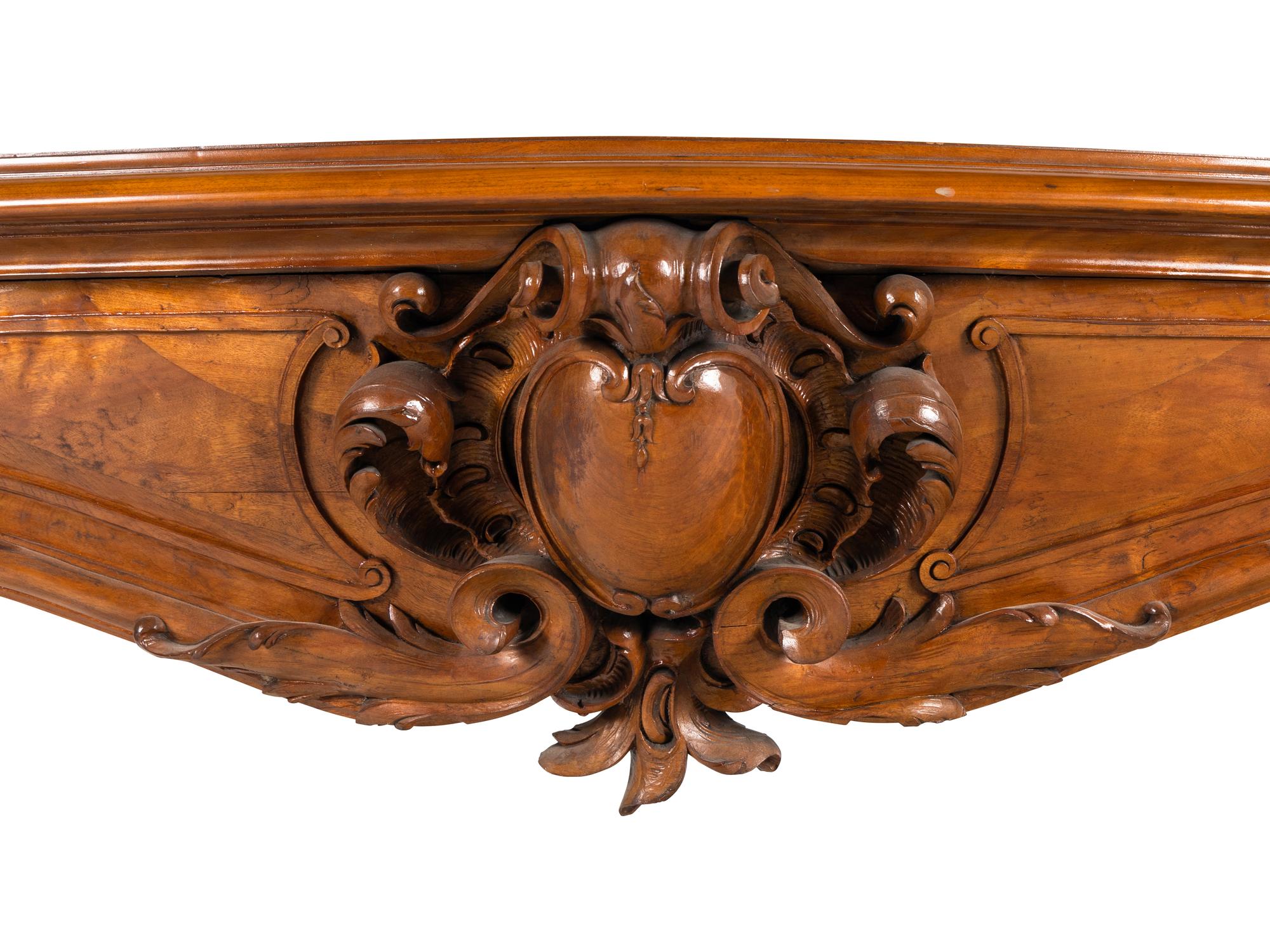 A Louis XV Style Carved Walnut Chimneypiece
