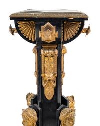A Pair of Egyptian Revival Gilt Bronze and Porcelain Mounted Ebonized Pedestals