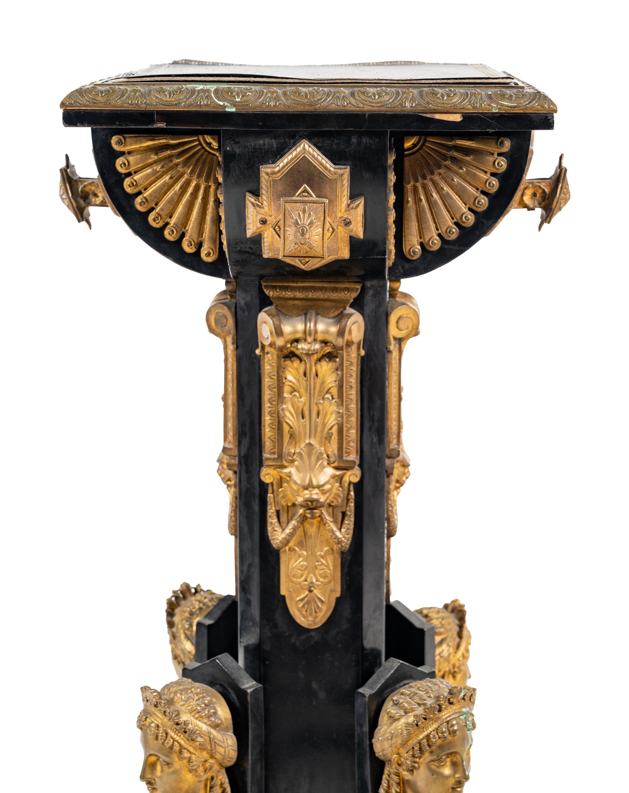 A Pair of Egyptian Revival Gilt Bronze and Porcelain Mounted Ebonized Pedestals