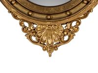 A Federal Style Eagle and Shell Giltwood Bull's Eye Mirror