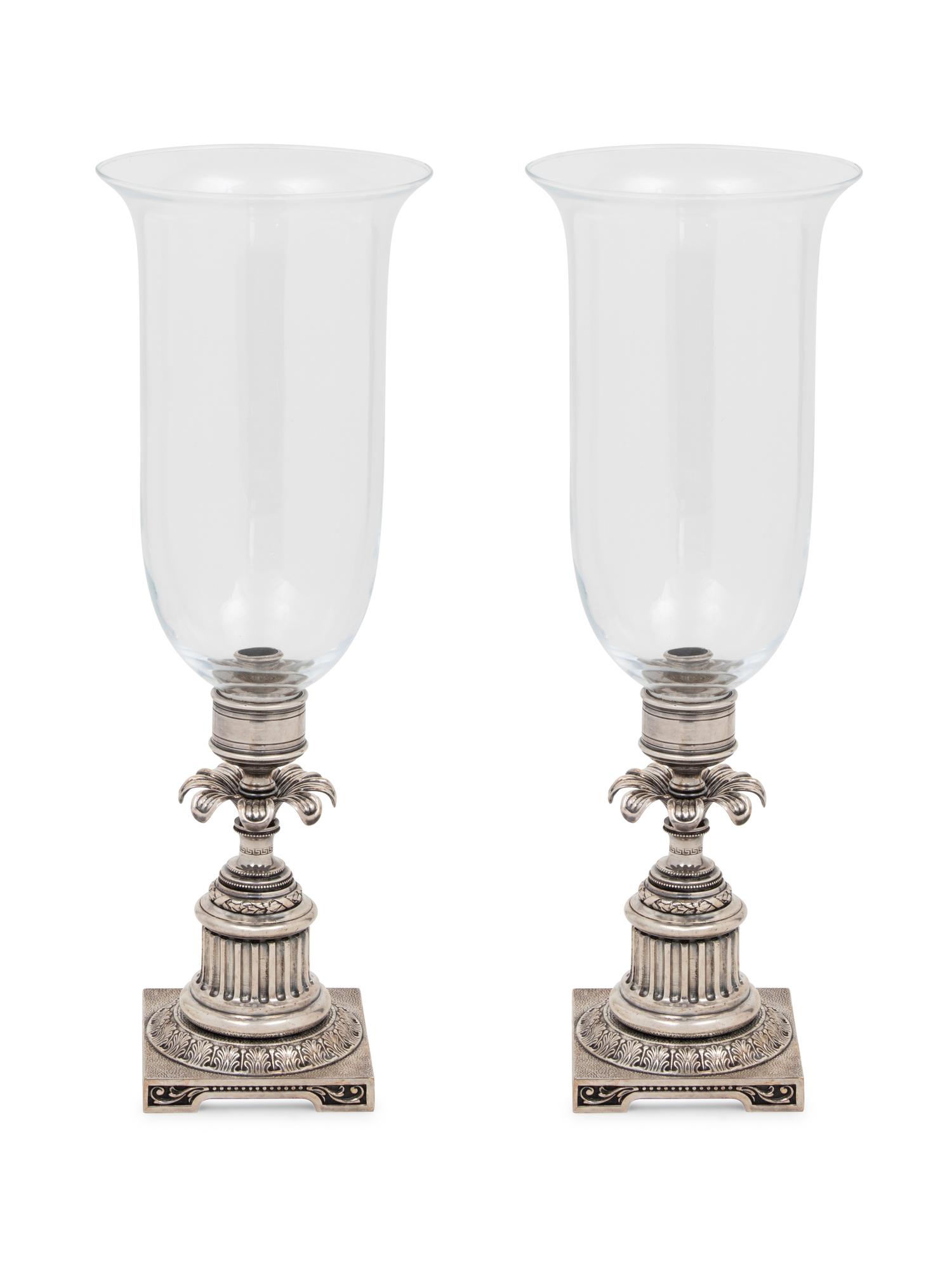 A Pair of Silvered-Metal and Glass Hurricane Candlesticks