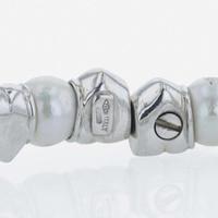 An 18K white gold, cultured pearl, and diamond bangle Italy