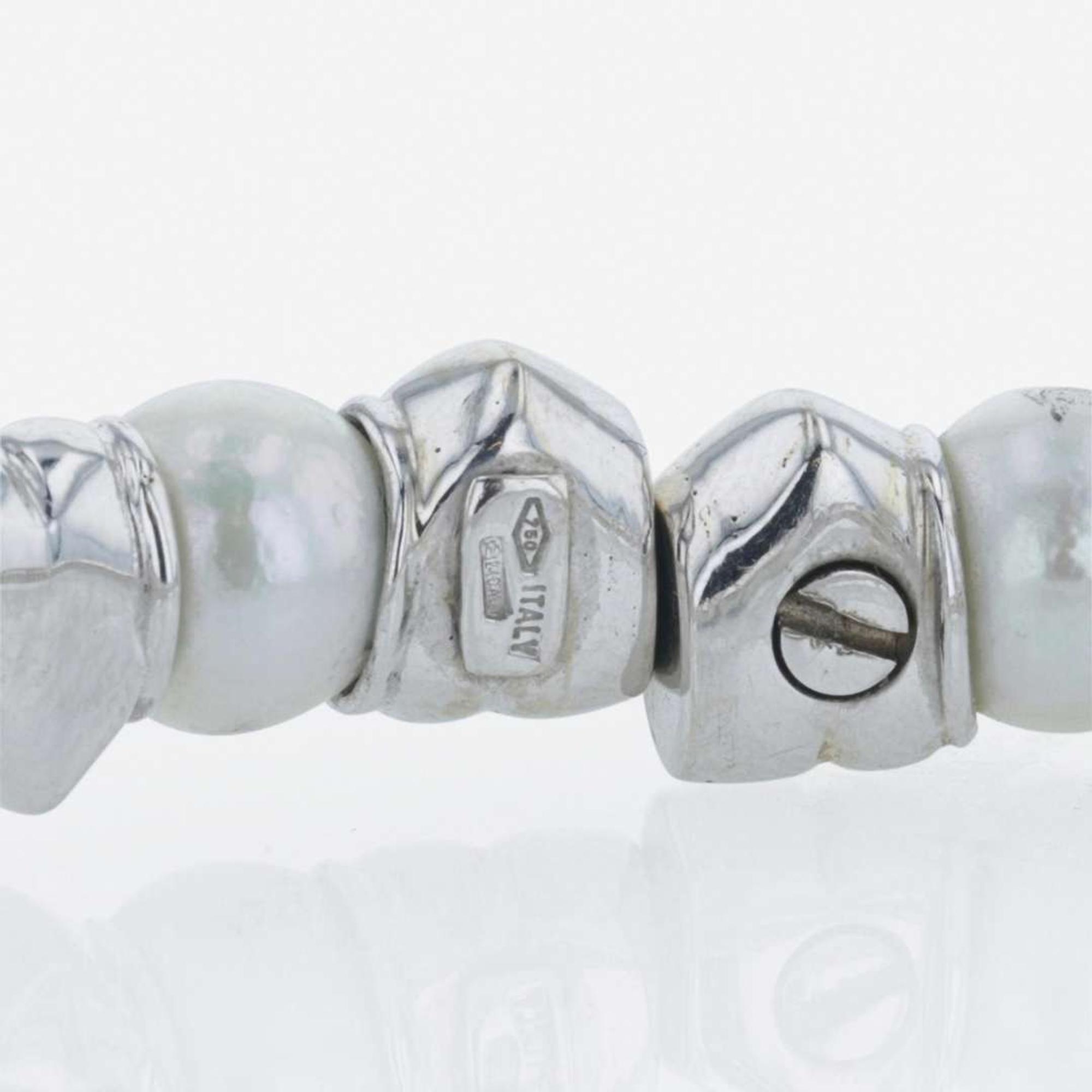 An 18K white gold, cultured pearl, and diamond bangle Italy
